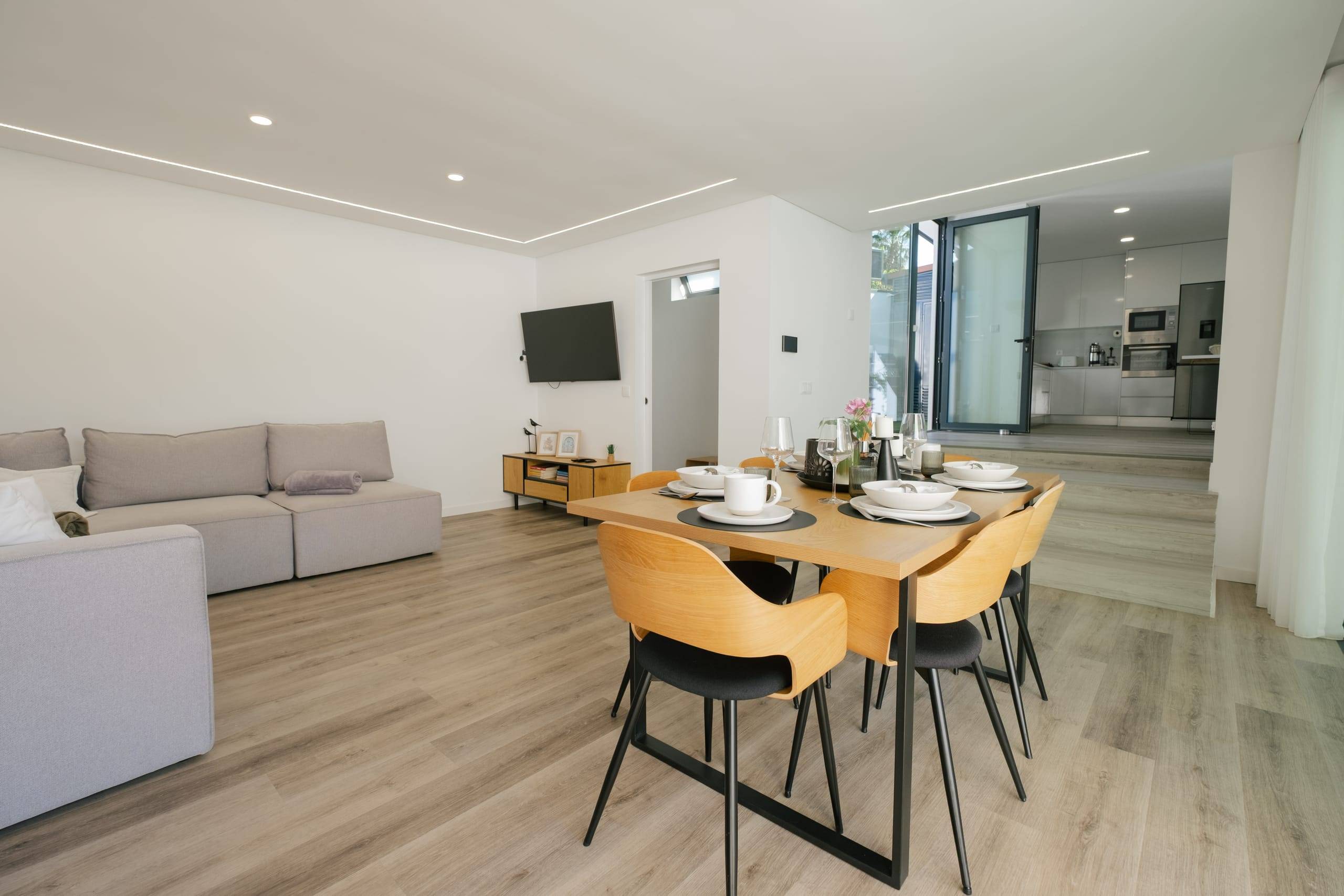 Open-plan living and dining room with sofa and table for six