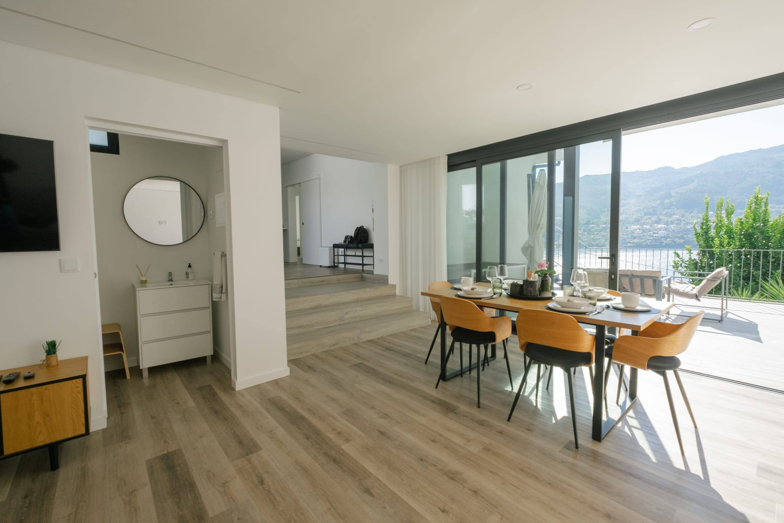 Bright dining room with glass doors to the terrace and lake