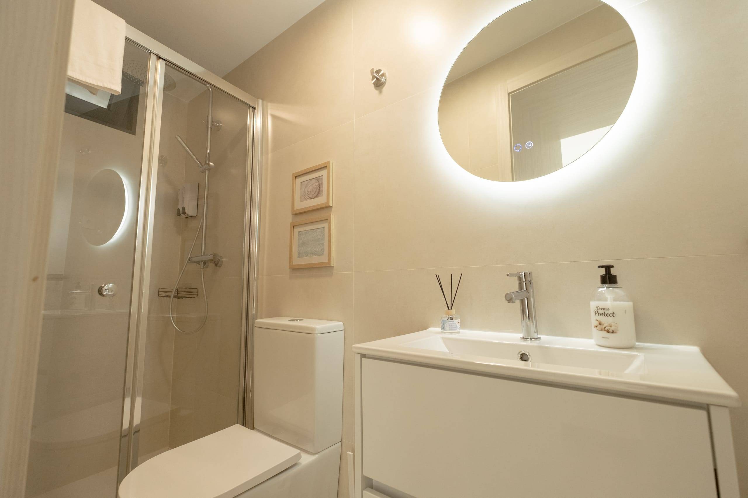 Suite bathroom with shower and illuminated mirror