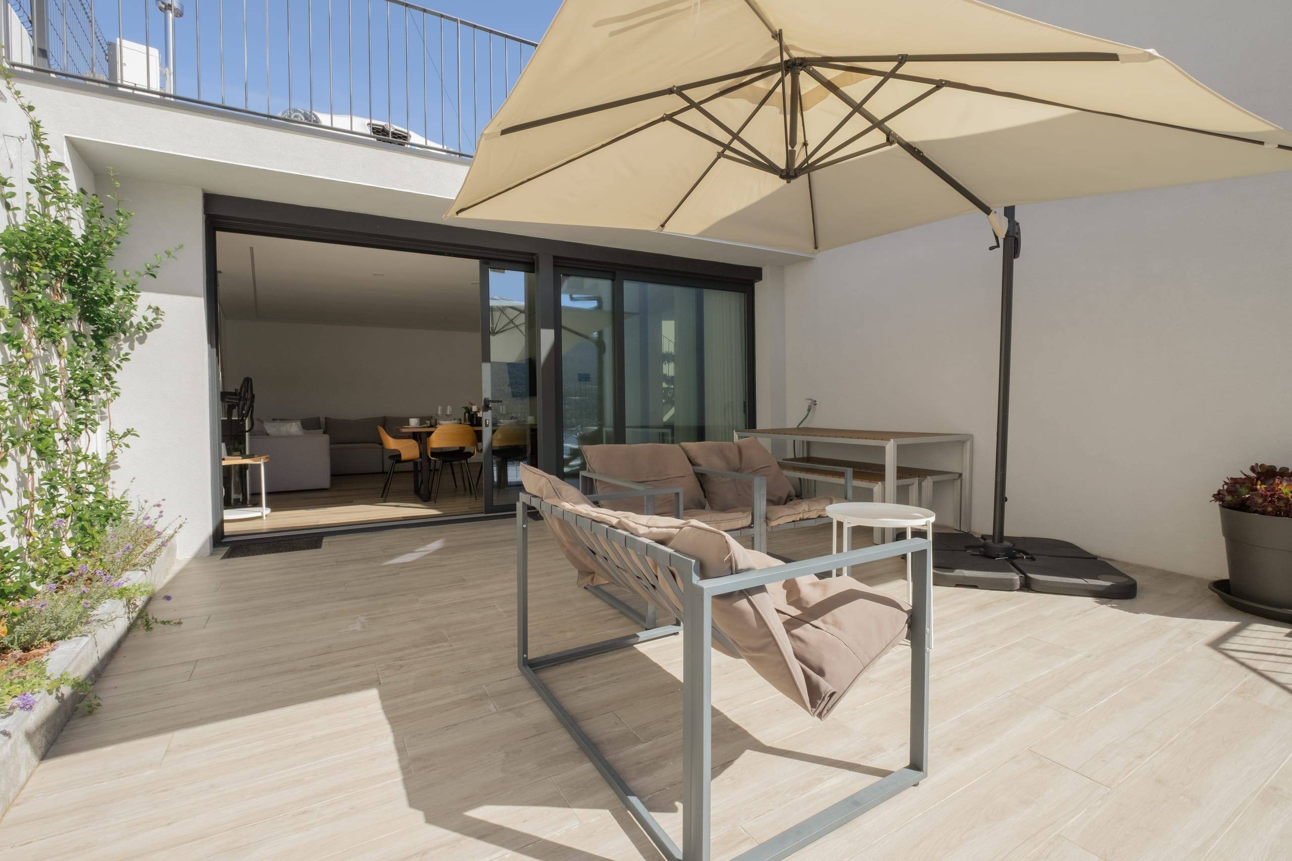 Terrace with parasol and direct access to the living room
