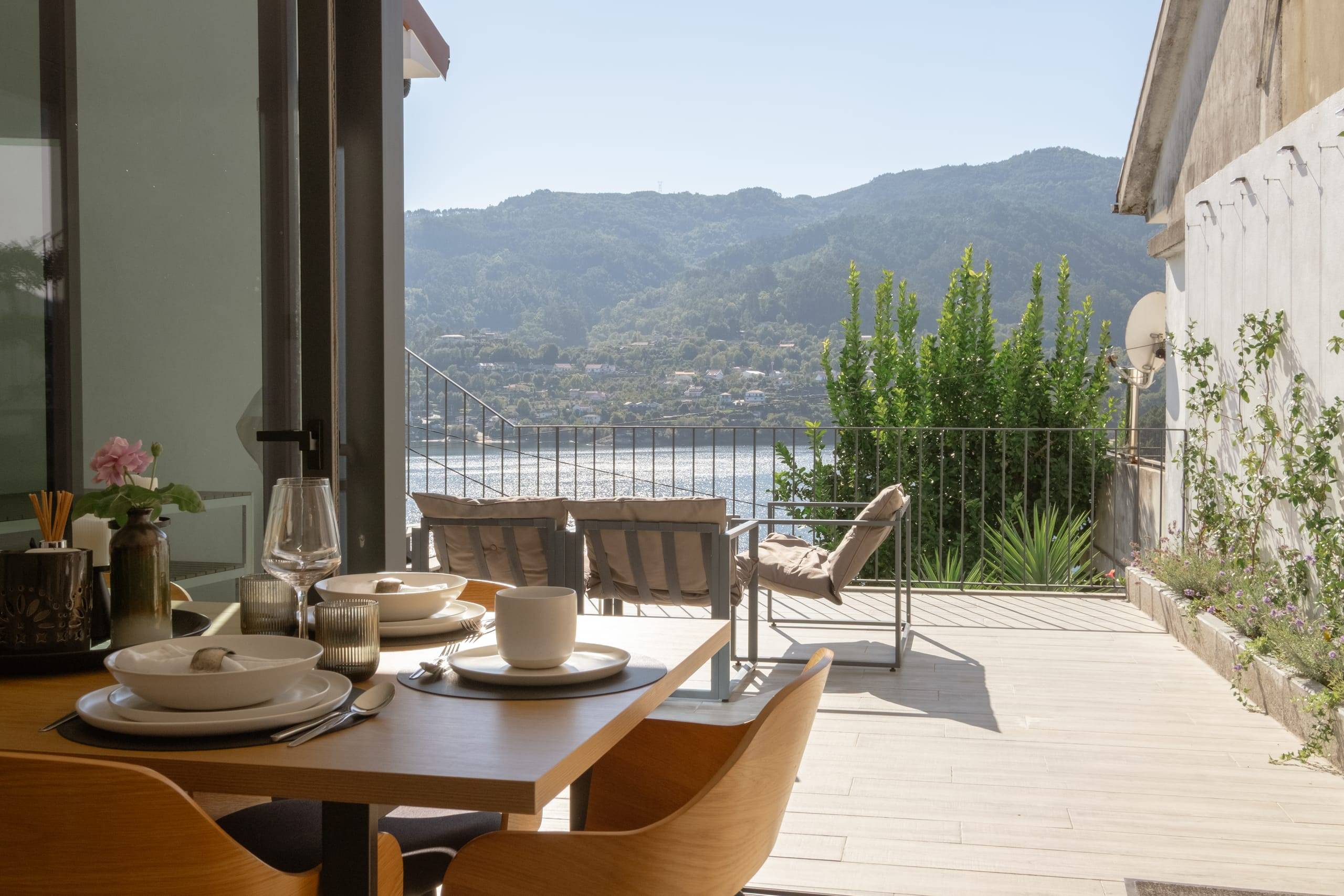 Table set on the terrace with views of the dam and mountains
